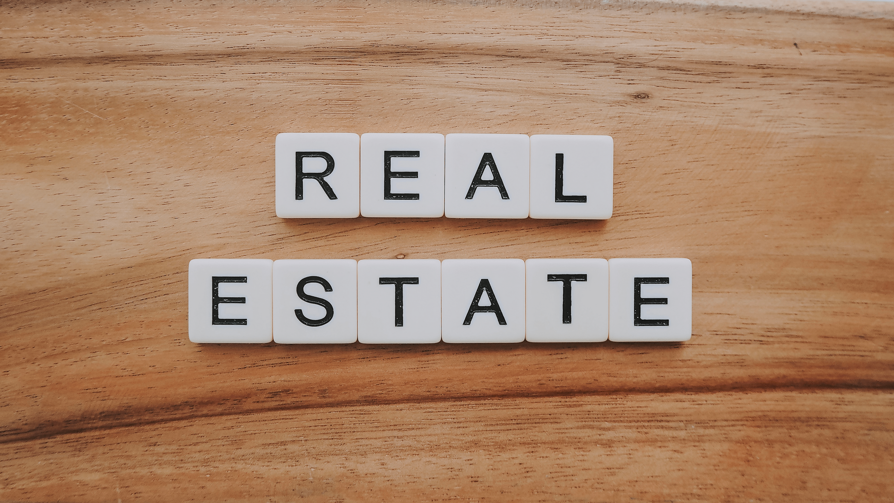 Scrabble Pieces spelling Real Estate- Dee Kumar Real Estate